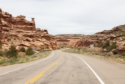 Scenic Road surrounded by Red Rock Mountains in the Desert. Spring Season. Moab Utah, United States. Adventure Travel.
