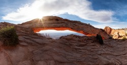 Scenic American Landscape and Red Rock Mountains in Desert Canyon. Spring Season. Sunset Sky. Mesa Arch in Canyonlands National Park. Utah, United States. Nature Background Panorama
