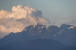Rocky Mountain Landscape with puffy clouds during sunset. Greater Vancouver, British Columbia, Canada. Nature Background.