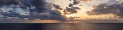 Dramatic Colorful Sunset Sky over Mediterranean Sea. Clouds with Sunrays. Cloudscape Nature Background. Panorama