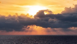 Dramatic Colorful Sunset Sky over Mediterranean Sea. Clouds with Sunrays. Cloudscape Nature Background.