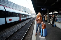 Young woman waiting a train on the station