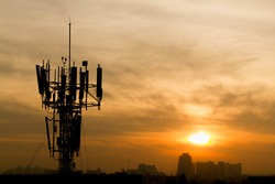 Mobile phone Telecommunication Radio antenna Tower with sunset sky, silhouette