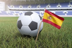 Spain flag in stadium field with soccer football