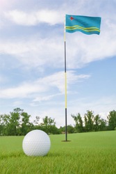 Aruba flag on golf course putting green with a ball near the hole