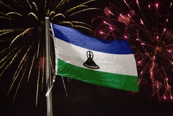 Lesotho flag blowing in the wind at night