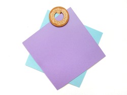 Blue and purple paper colors was clipped with wooden clip in doughnut shape isolated on white background with note space. It can write text on paper note or on white space. 