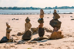 4 stone figures on the beach