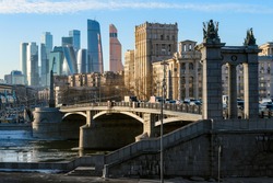 Landscape of modern Moscow city skyscrapers and ancient city architecture. Fantastic view of Borodinsky bridge on river Moscow, old buildings and high towers of Russia capital downtown. Moscow, Russia