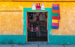 Traditional indigenous clothing shop with colorful facade in Santo Tomas Jalieza, Oaxaca state, Mexico.