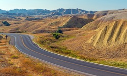 Yellow Mounds with highway in summer, Badlands national park, South Dakota, USA.
