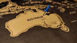 Close up of Australia map with blue pin.