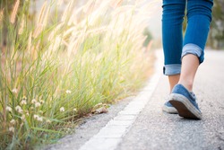 Walking women jeans and sneaker shoes
