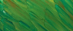 Texture of green paint with glitter. Abstract earth color background from palette knife strokes. Close-up of green shades with sparkles