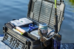 A large fisherman's tackle box fully stocked with lures and gear for fishing.fishing lures and accessories. fishing spinning. Kit of fishing lures.