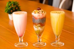 Long glasses of milkshakes with, strawberry, banana, with ice cream and Falooda or fresh faluda juice. Shakes and smoothies. Milk shake and cocktail for summer.