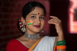 Beautiful Indian female Tricolour flag painted on face celebrating Independence day Republic Day