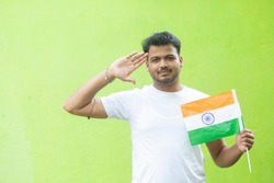 Young man with indian flag or tricolour doing salute. Azadi Ka Amrit Mahotsav 