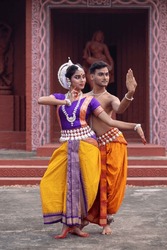 two dancer posing indian classical dance form Odissi. Ancient scriptures of india backdrop Classical Dance