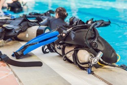 Equipment for diving is on the edge of the pool, ready for a lesson.