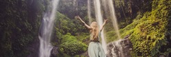 Woman in turquoise dress at the Sekumpul waterfalls in jungles on Bali island, Indonesia. Bali Travel Concept BANNER, LONG FORMAT