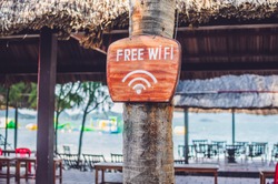 Free WiFi arrow on the beach. Internet everywhere concept