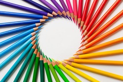 Crayons - colored pencil set loosely arranged  on white background. Round frame.