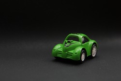 Green car toy with blur black background