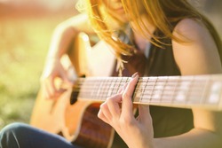 Girl playing the guitar. Fragment
