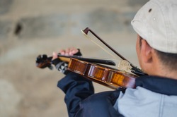 Street musician playing violin,Selective focus 