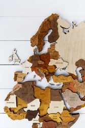 Wooden world map on a white background. Handmade. Plywood. In brown tones. The countries of Europe and South Africa. Mediterranean Sea. Top view. Tourism and travel. Woodwork.