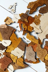 Wooden world map on a white background. Handmade. Plywood. In brown tones. The countries of Europe and South Africa. Mediterranean countries. View from above. Tourism and travel. Woodwork.