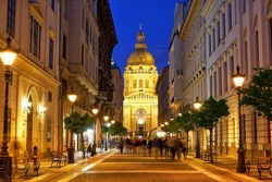 Zrinyi Utca street and Saint Stephen`s Basilica in Budapest at night. Hungary.                            