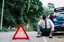 Asian businessman broken car engine breakdown his stressed problem, Accident emergency on the mountain road outdoor late for work concept.