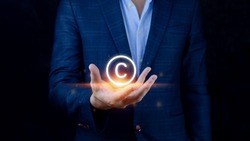 Businessman holding Copyright icon, patents and intellectual property protection law and rights. with symbol of the copyright.copyright symbol from the author.