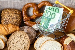 Shopping basket with Euro money around groceries, Breads and pastries. The concept of inflation, rising prices and more expensive food in the European Union countries 