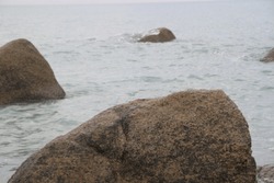 large rock visible in the sea