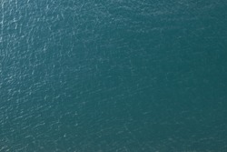 Vast blue ocean background with moderate waves looking straight down