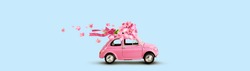 Pink toy car with bouquet of flowers on a roof with ribbon and bow on blue background. Flowers delivery.