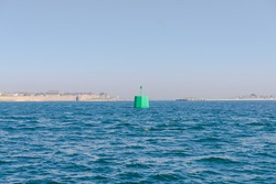 Green buoy in the sea in Brittany, France