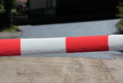 Red and white lock tape on a road