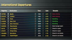 Airport flight information displayed on departure board, flight status changing
