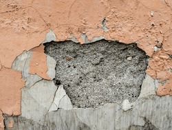 These orange walls deteriorate due to weathering and watering. The outside of this wall is often exposed to rain and water seeps. Parts of the wall fall off.