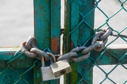 The padlock and chains on a steel post