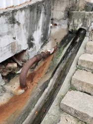 Old rusted drain pipe in brown and grey