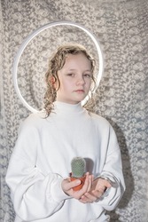 girl with a halo holds a holy cactus