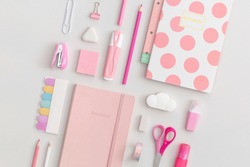 Pink school stationery on a grey background. Top view. Flat lay. Back to school concept.