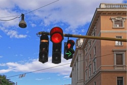 Capturing the essence of urban traffic regulation, this image showcases the essential traffic light system at a bustling city intersection. The red, yellow, and green lights stand as silent sentinels.