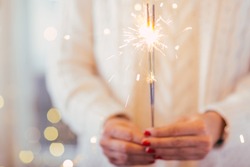 Close up of woman hands holding sparkler