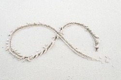 Infinity symbol of sand on the beach